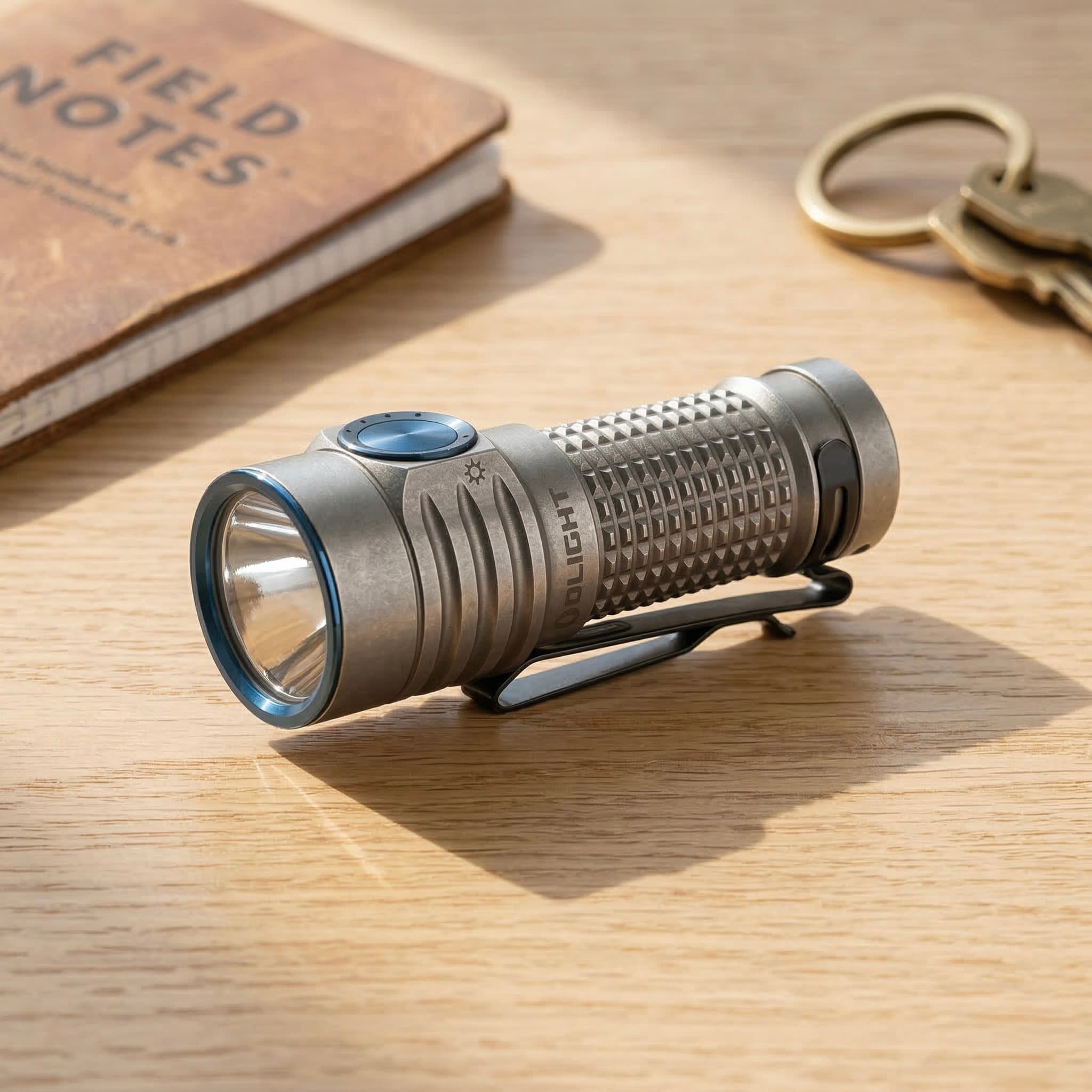 Olight Baton 3 flashlight on a wooden surface